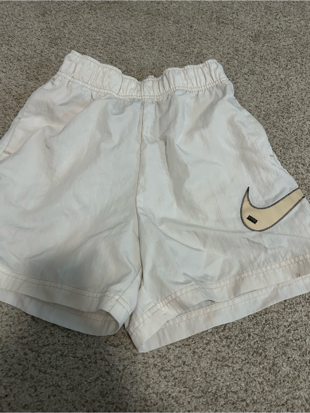 Nike Women's White Athletic Shorts with Beige Swoosh